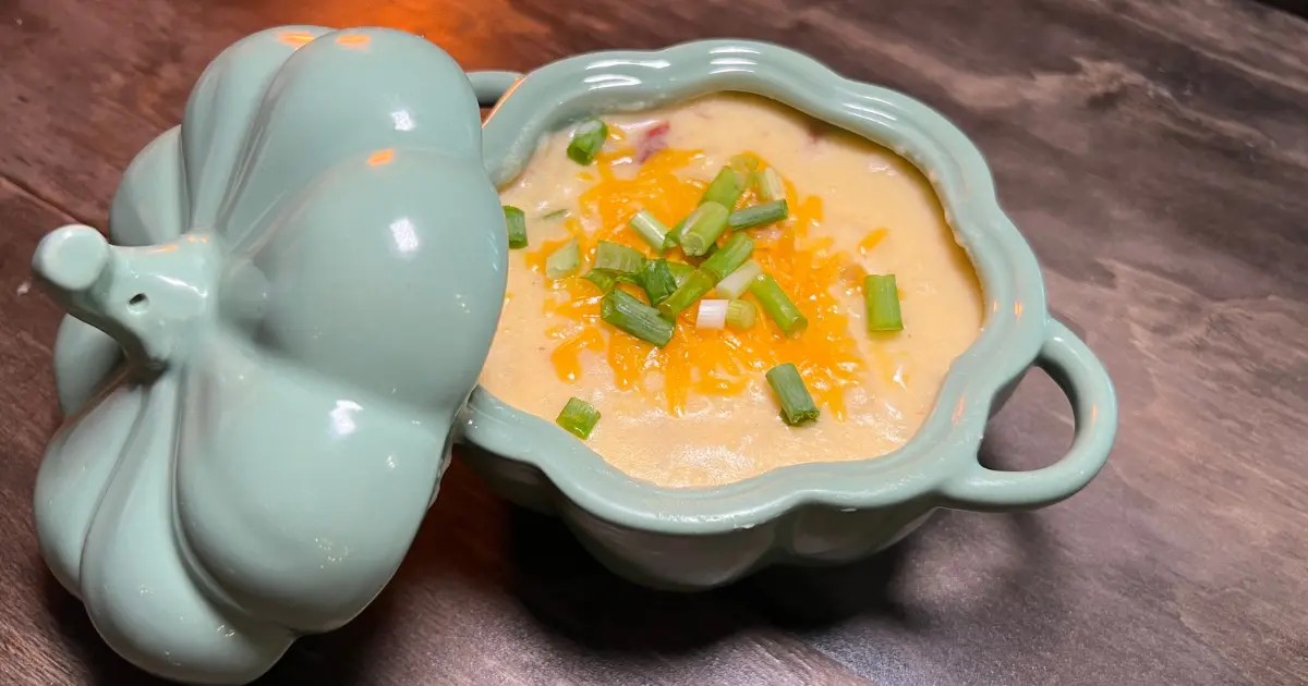Rustic smoked potato soup in a ceramic bowl, cozy kitchen setting