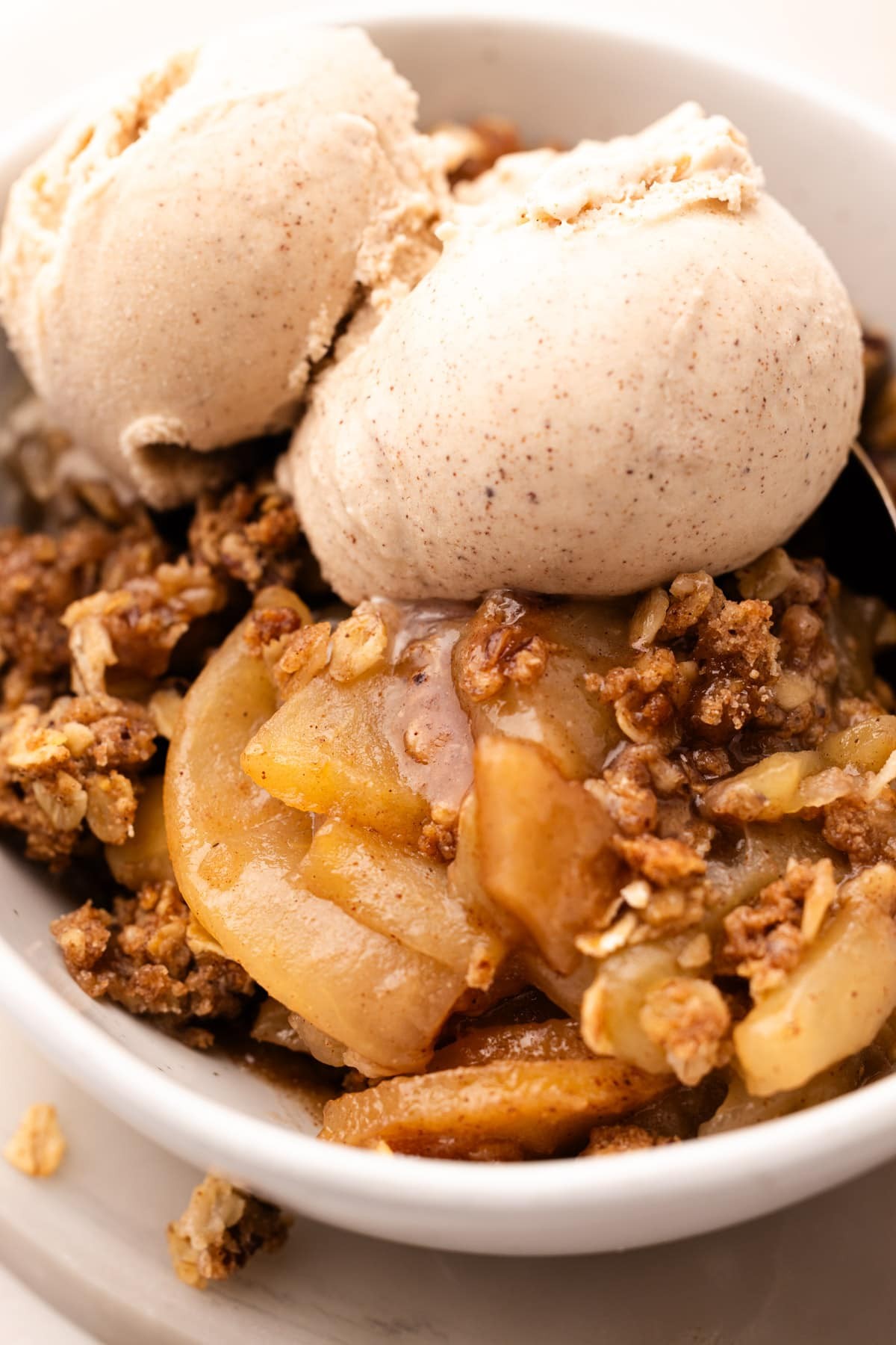A rustic apple crisp with a dark chocolate crust, served warm with a scoop of vanilla ice cream