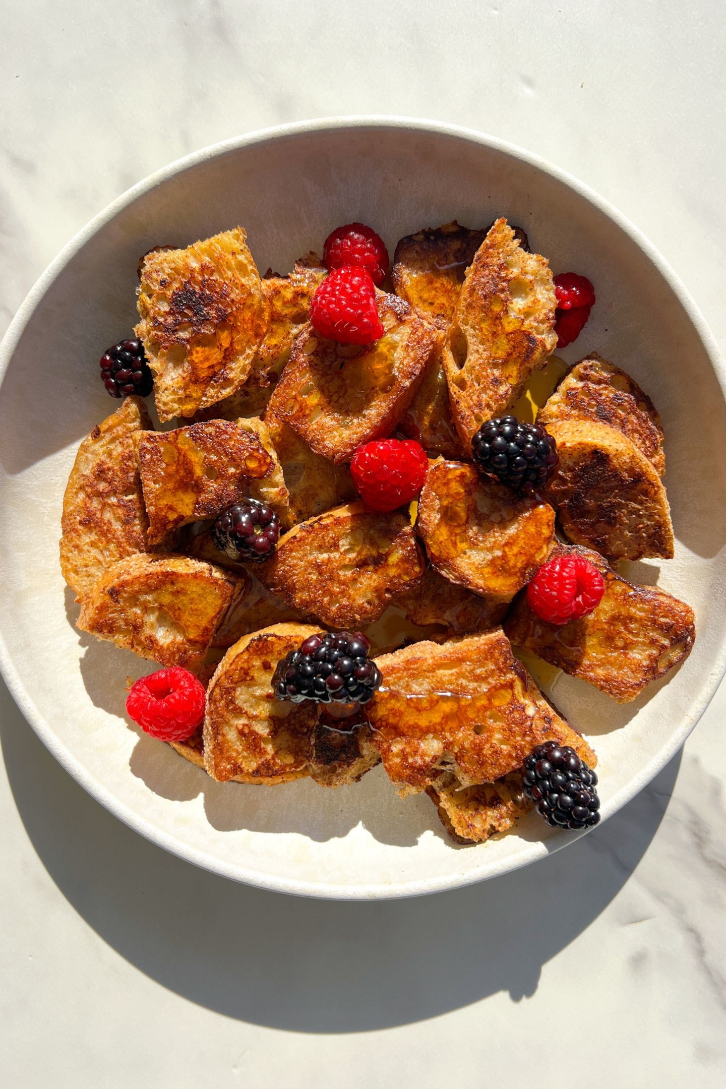 Golden brown, crispy French toast bites on a plate