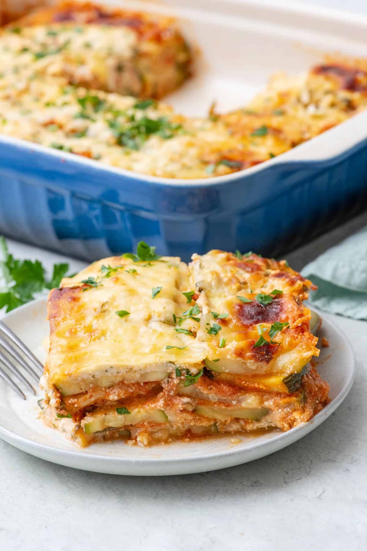 A delicious-looking zucchini lasagna with a Mediterranean twist, showcasing layers of zucchini, ricotta, and herbs.