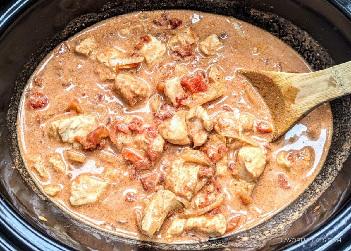 Close-up shot of a slow cooker chicken paprikash stew with paprika dusting