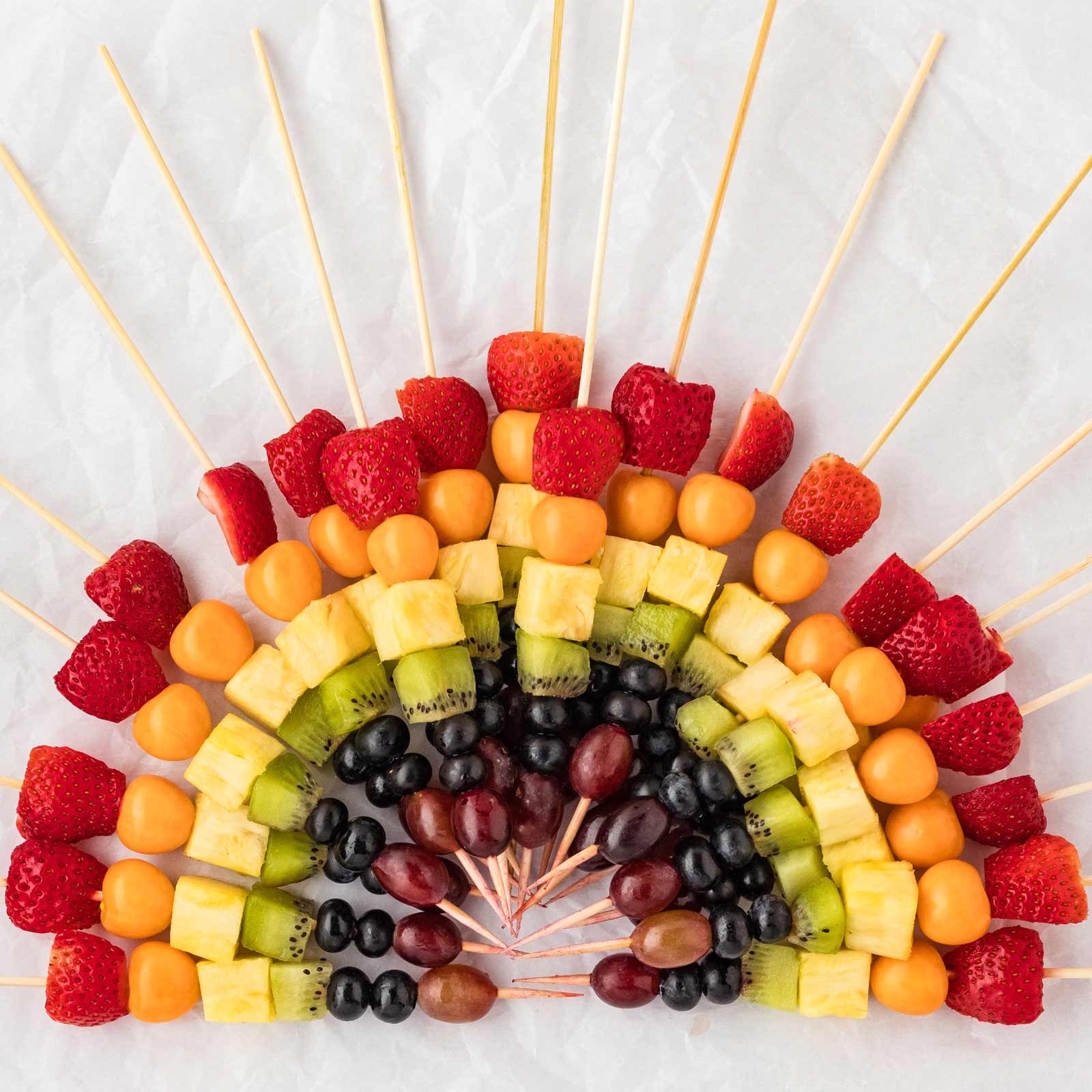 vibrant fruit skewers arranged like a rainbow