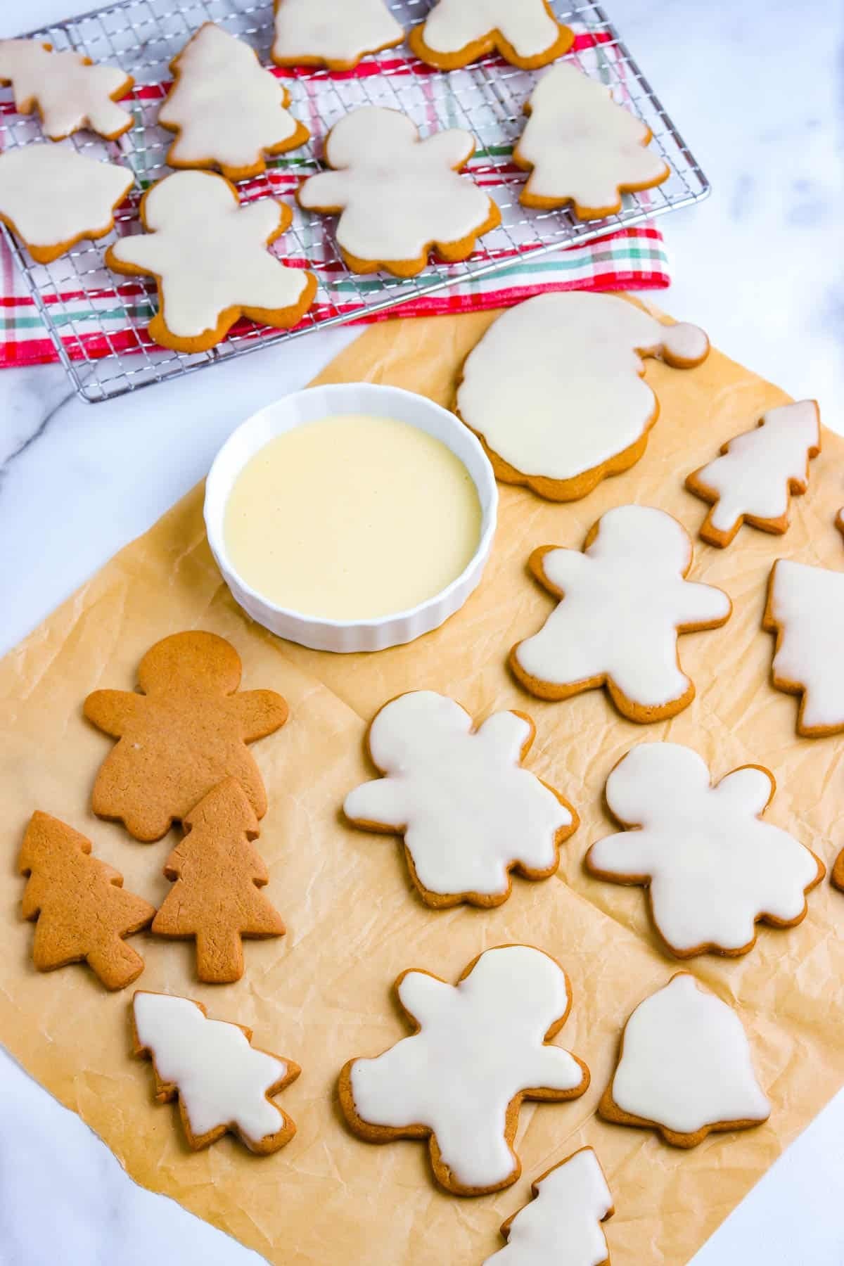 freshly baked gingerbread cookies decorated with orange glaze on a festive plate, warm lighting