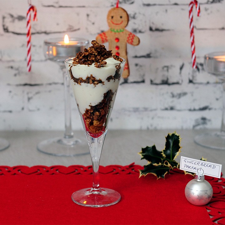 Gingerbread parfaits with yogurt and granola in clear glass