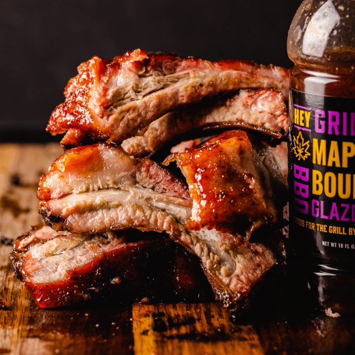 Smoked ribs with a glistening maple bourbon glaze, close-up shot