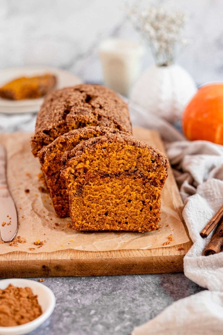 homemade pumpkin streusel bread on a wooden cutting board