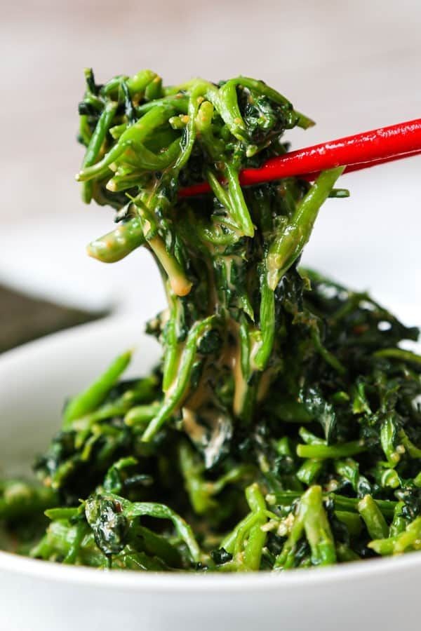 steamed watercress with sesame oil and rice vinegar served on a plate