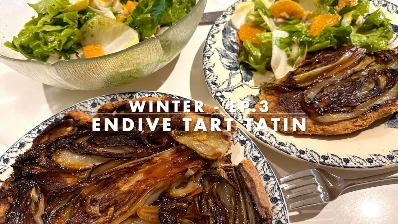 close up shot of golden brown Endive Enchantment Tartlets on a wooden serving board