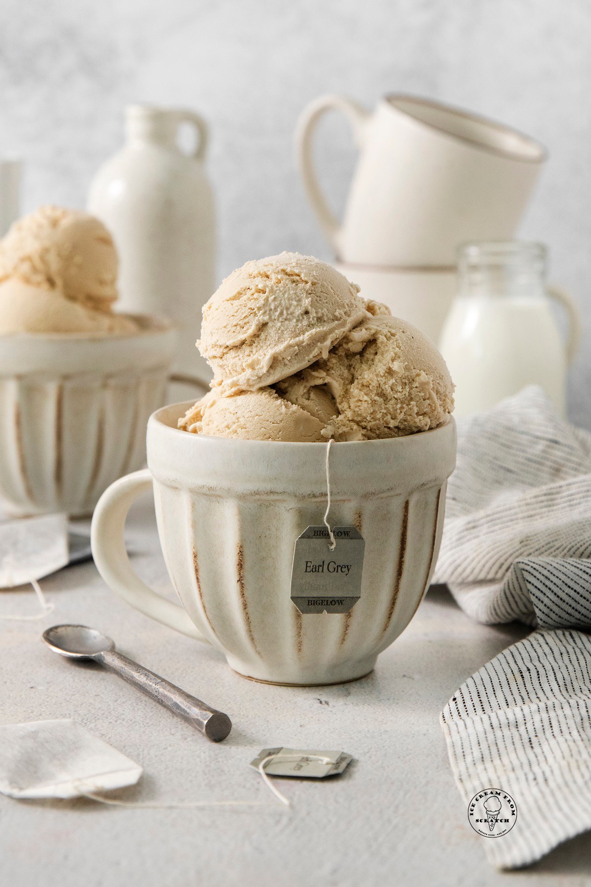 scoops of dairy-free Earl Grey tea ice cream in a bowl with tea leaves