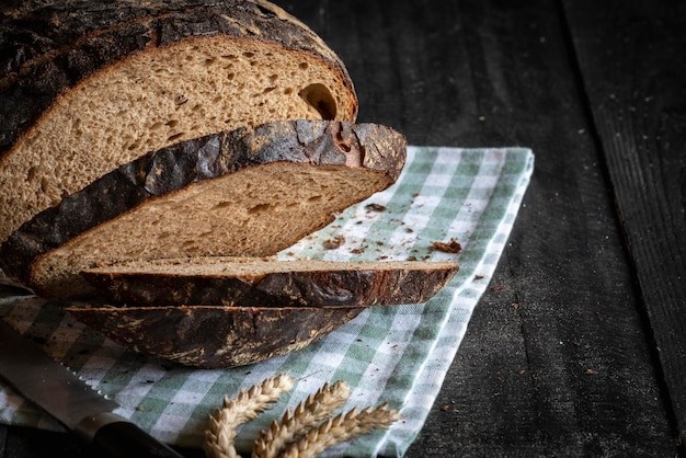 close up of freshly baked rye bread loaf on a wooden cutting board