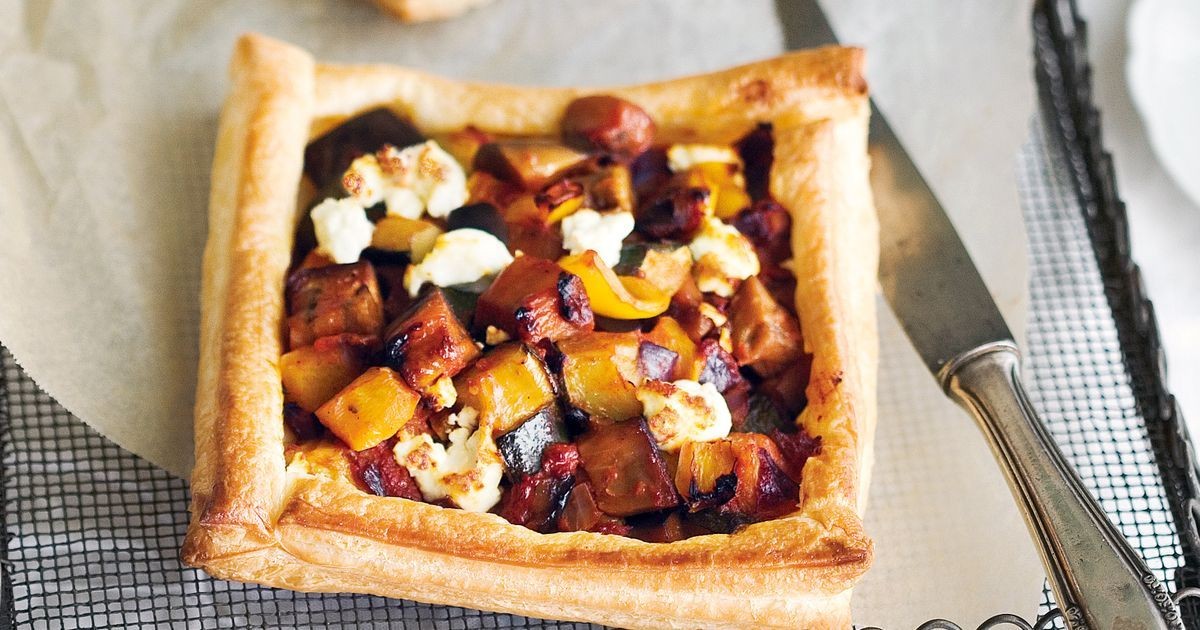 Close-up shot of golden brown ratatouille tartlets with melted cheese
