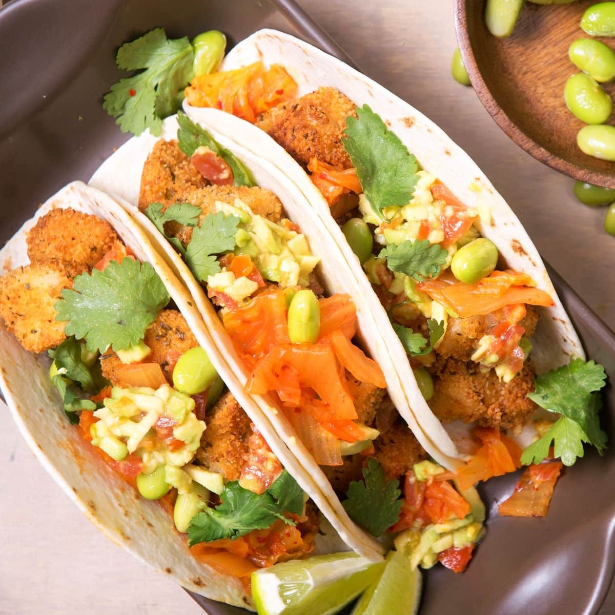 Close-up shot of vibrant Kimchi Orange Salad Tacos with fresh cilantro garnish