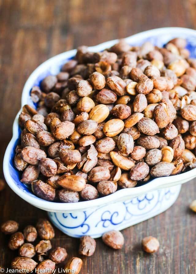 Close-up shot of roasted peanuts with five-spice powder, scattered on a wooden surface