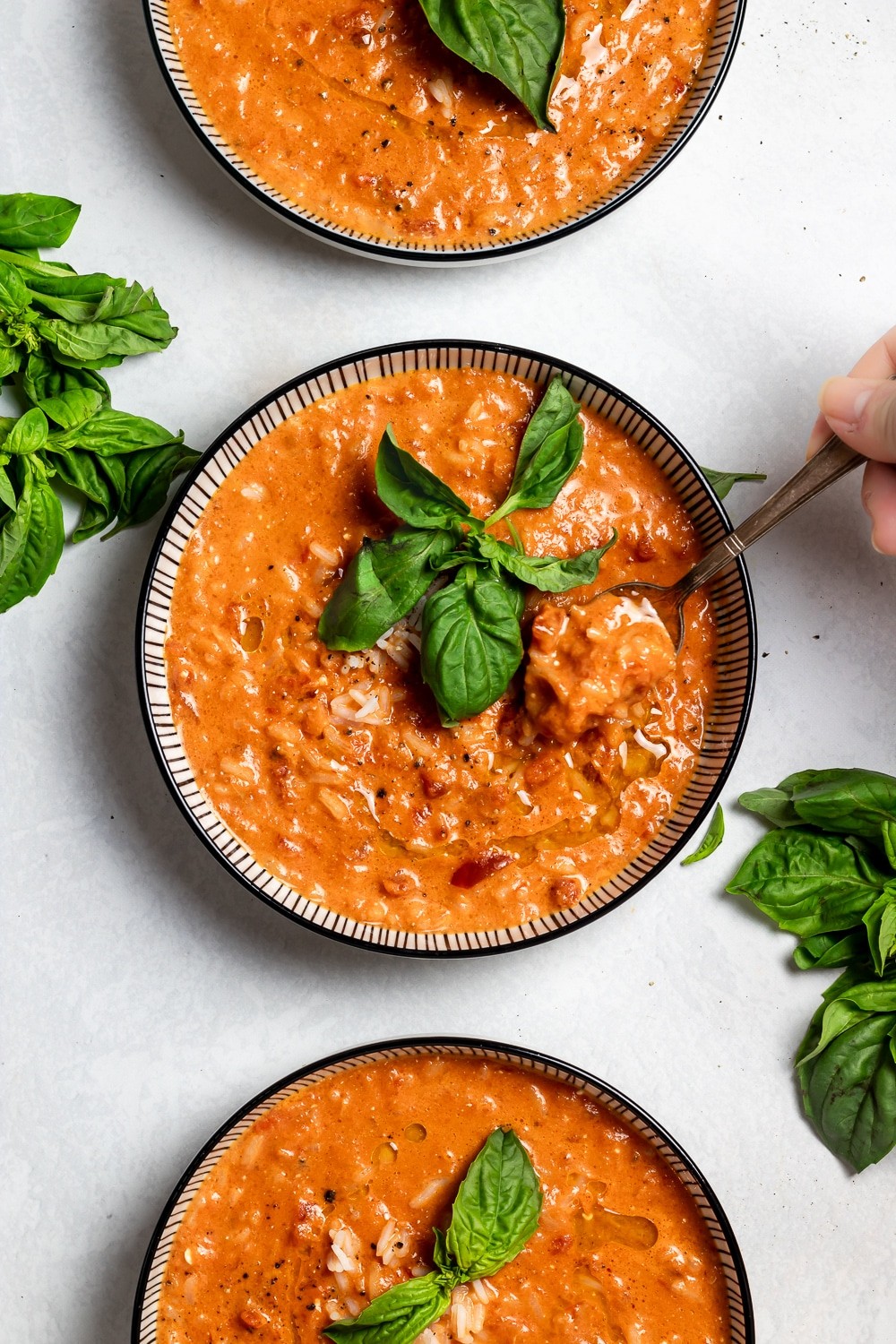 Creamy tomato rice bowl with fresh basil garnish