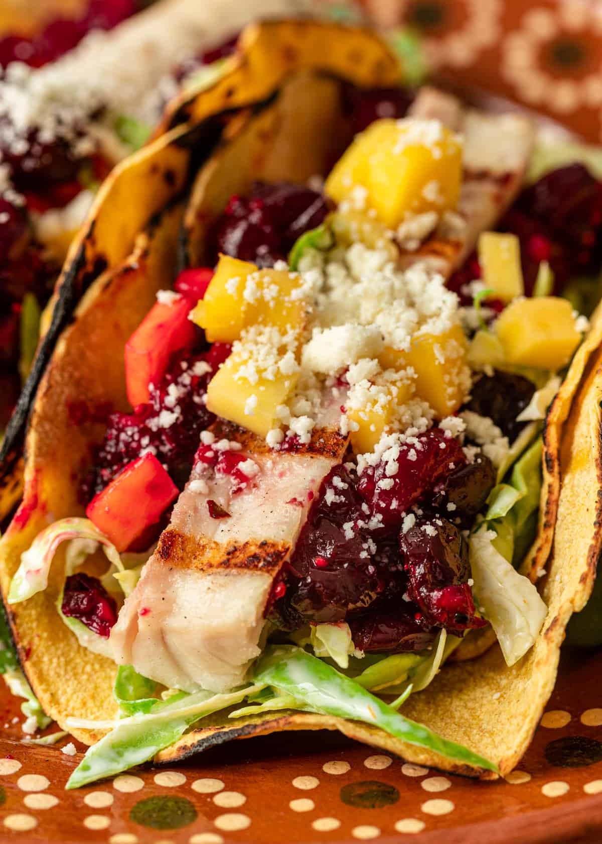 Close-up shot of delicious mahi-mahi tacos with vibrant toppings