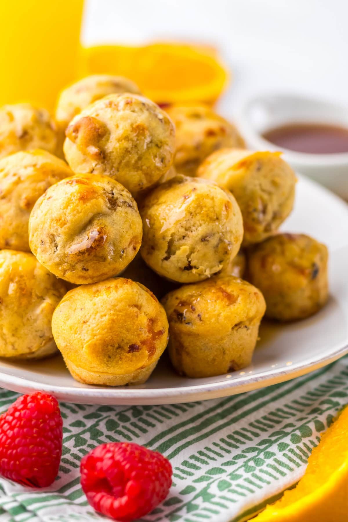 Close-up shot of homemade McGriddle bites with maple syrup and sausage on a plate
