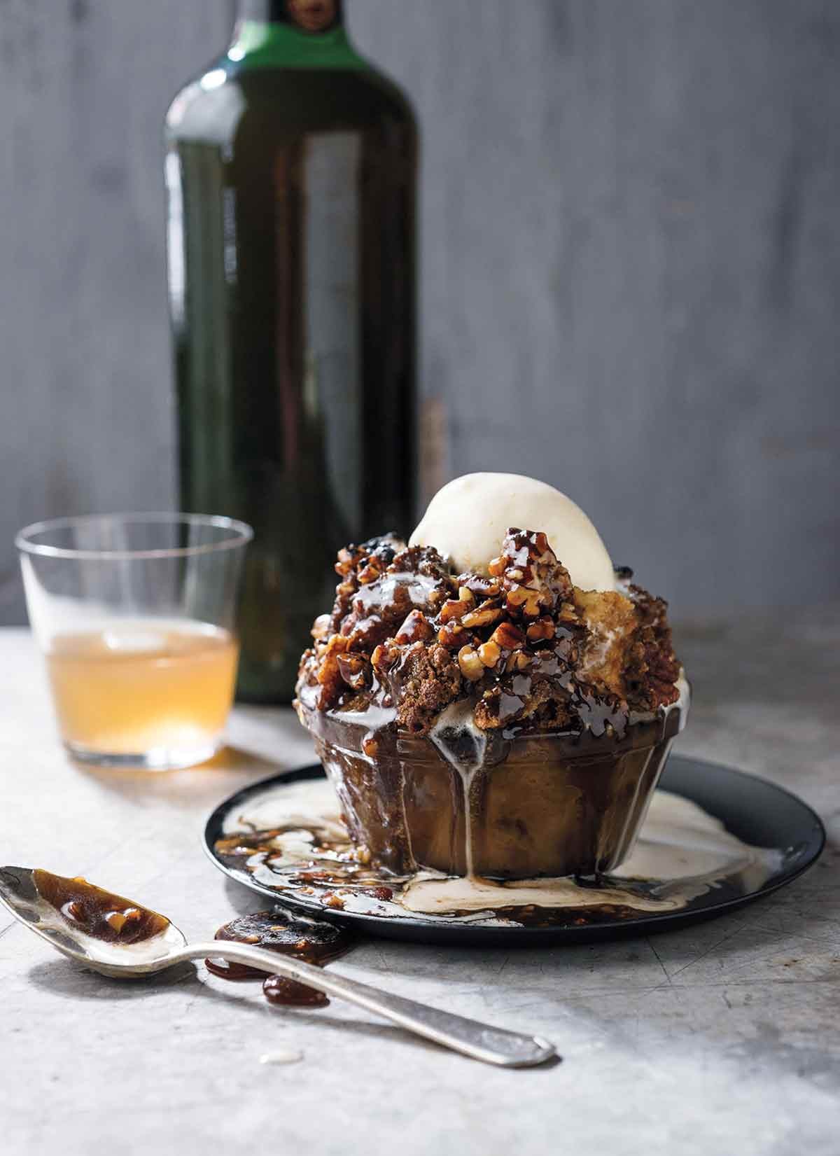 A warm slice of bourbon pecan bread pudding with a scoop of vanilla ice cream