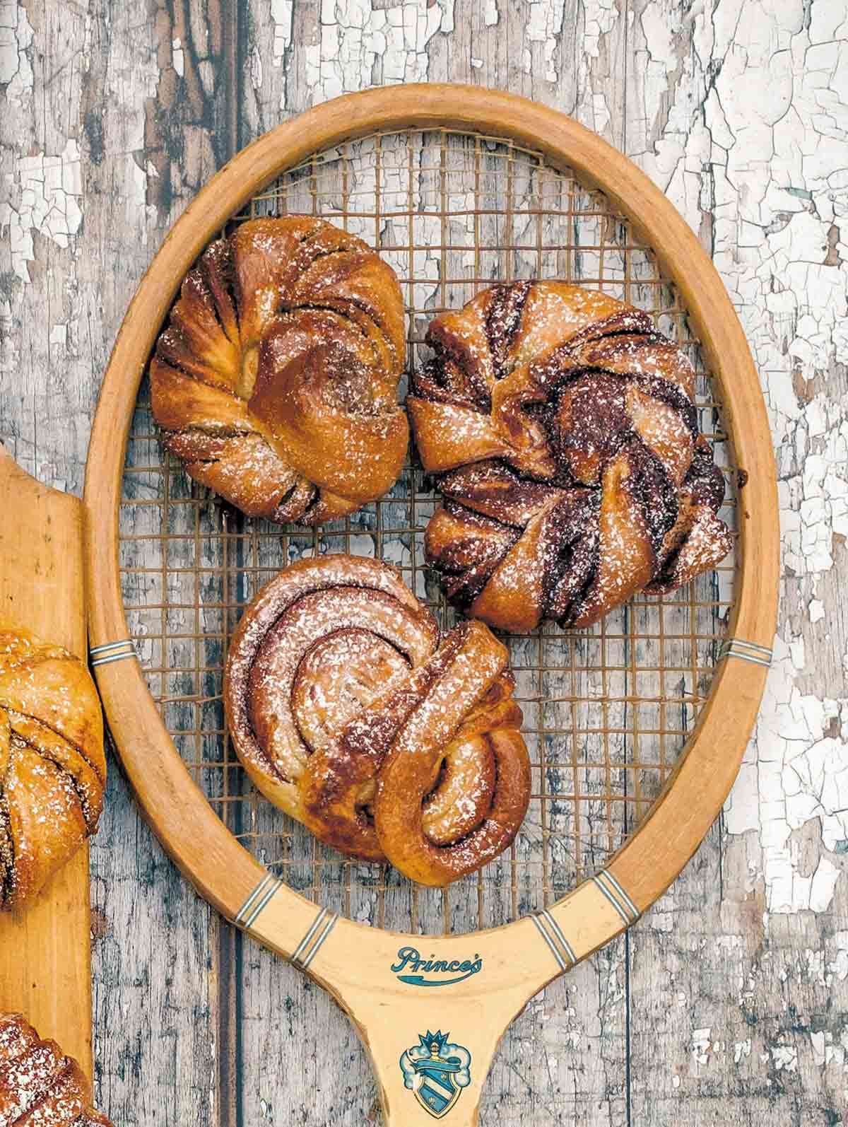 Lingonberry Cardamom Rolls on a wooden board