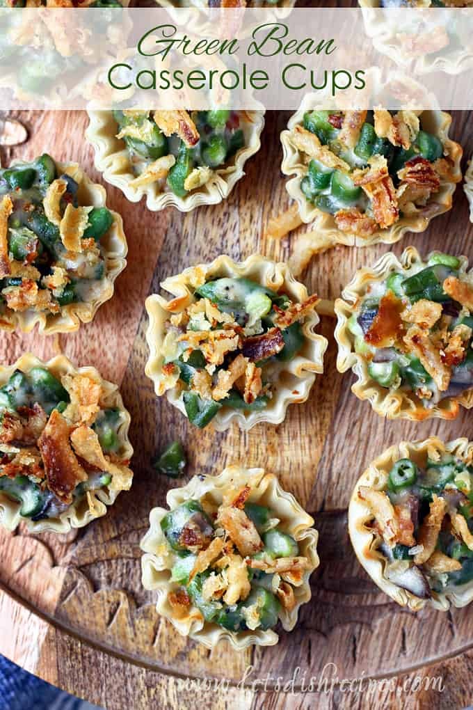 Baked green bean casserole cups on a serving platter, cozy Thanksgiving table setting with autumn leaves