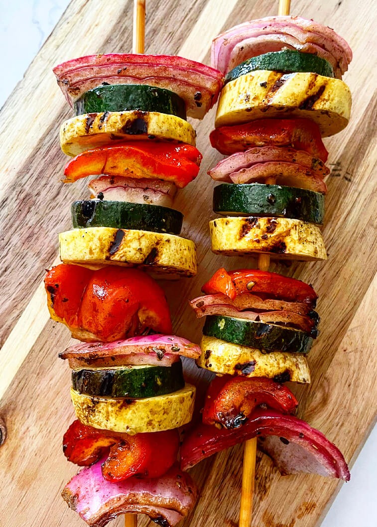 Vegetable souvlaki skewers with balsamic vinaigrette drizzled on top