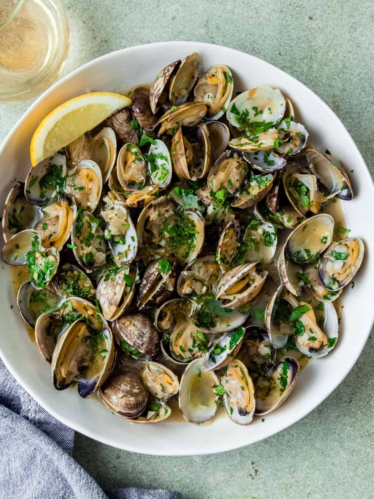 close-up shot of roasted clams with white wine and garlic, glistening