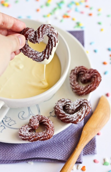 raspberry white chocolate churros being drizzled with white chocolate sauce
