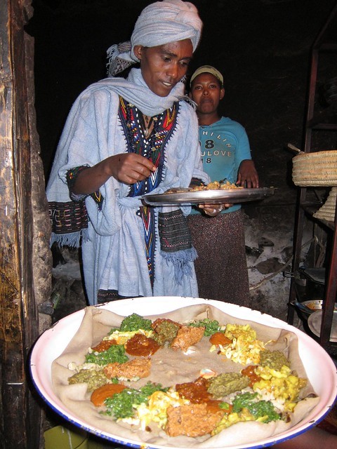 Ethiopian woman preparing injera with spiced butter