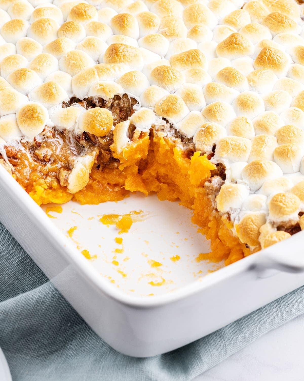 golden sweet potato casserole with perfectly toasted marshmallows close up