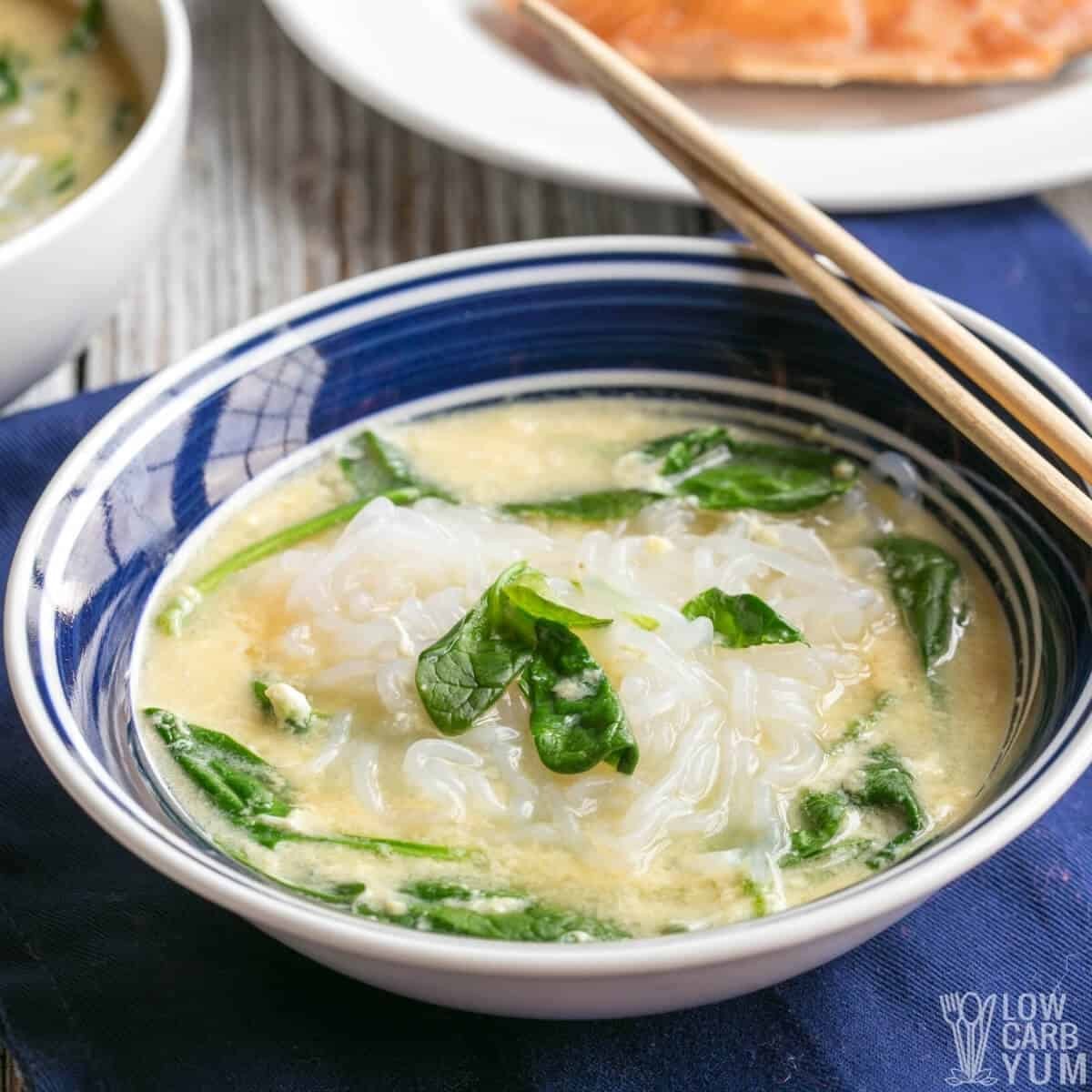 A steaming bowl of keto shirataki noodle soup with pork and vegetables