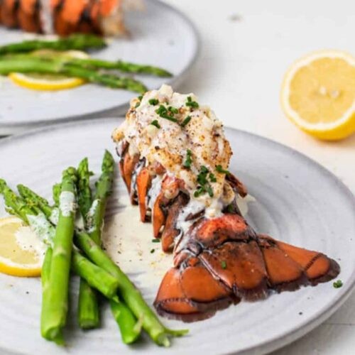 Plated Garlic Butter Lobster with perfectly roasted asparagus