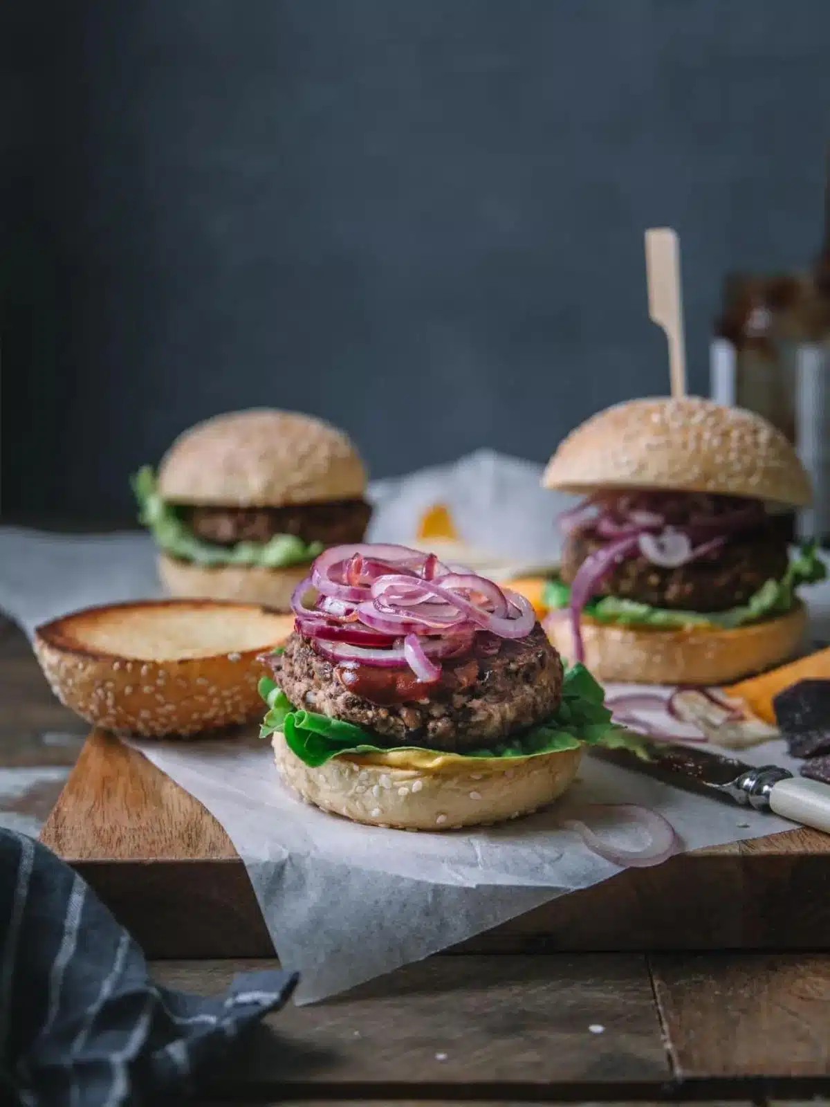 roasted vegetable and black bean burgers on a wooden board