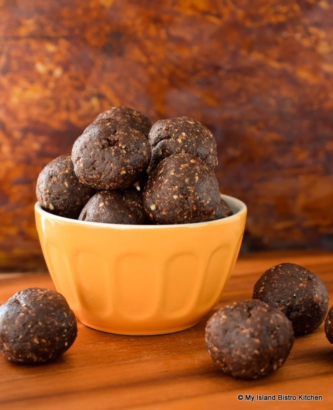 close up shot of coffee date energy bites on a rustic wooden surface