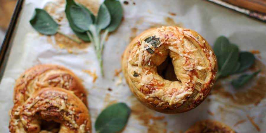 sage and brown butter bagel on a wooden board