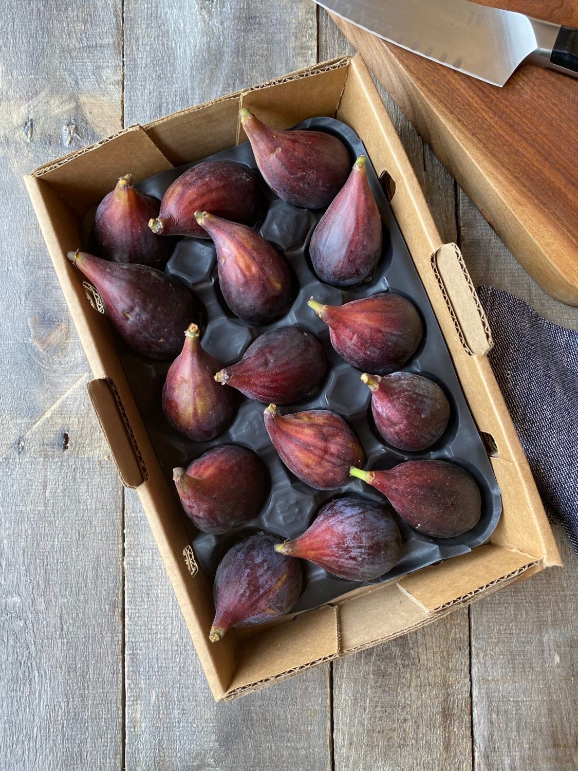 prepared figs with flax seeds on a wooden table