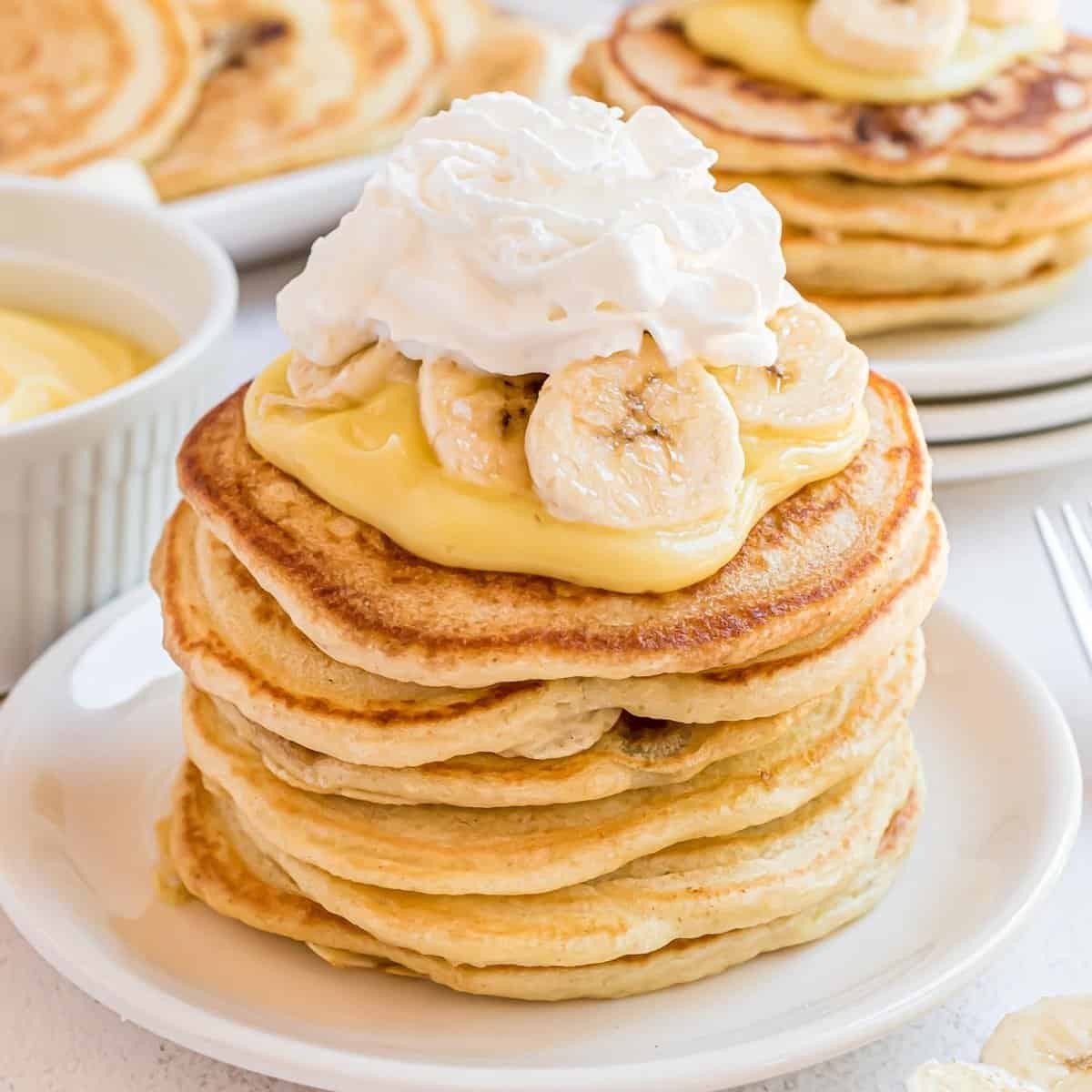 Delicious banana pancakes with whipped cream topping