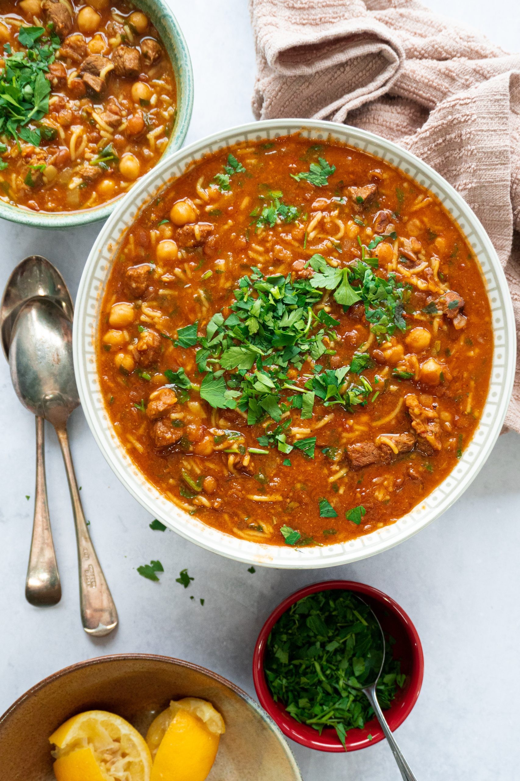 A hearty bowl of lentil soup with crispy chickpeas, garnished with fresh parsley