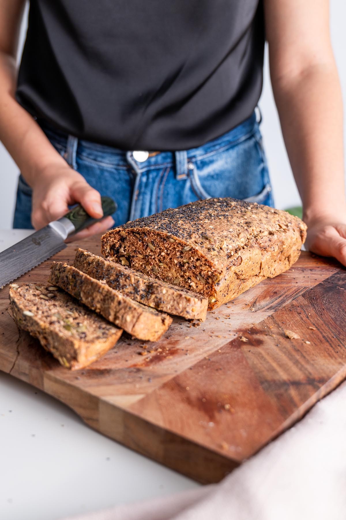 buckwheat chia seed sourdough loaf on a wooden cutting board