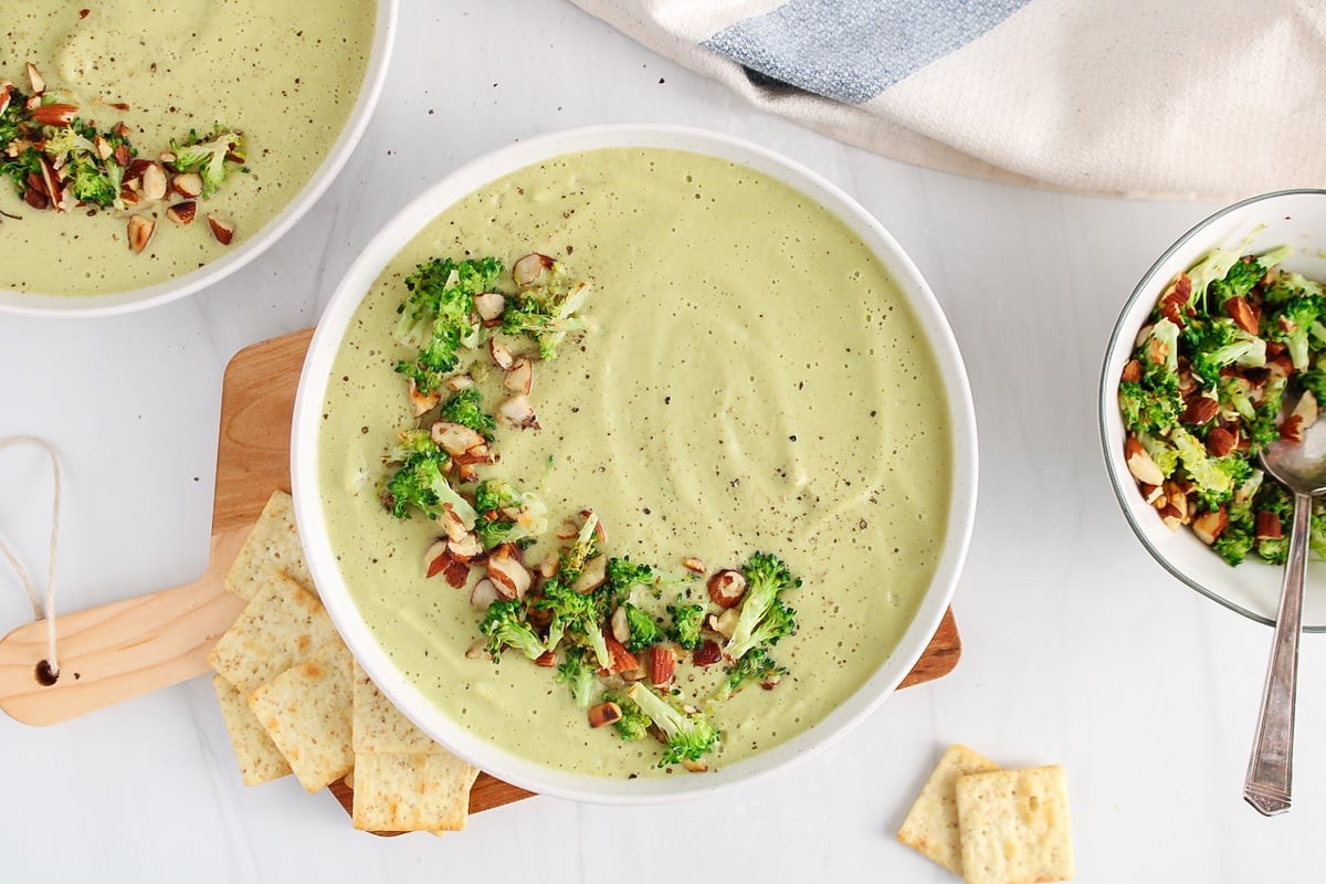 creamy vegan broccoli soup garnished with toasted almonds