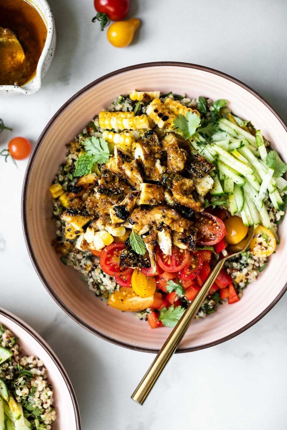 Healthy chicken bowl with fresh herbs and quinoa, brightly lit