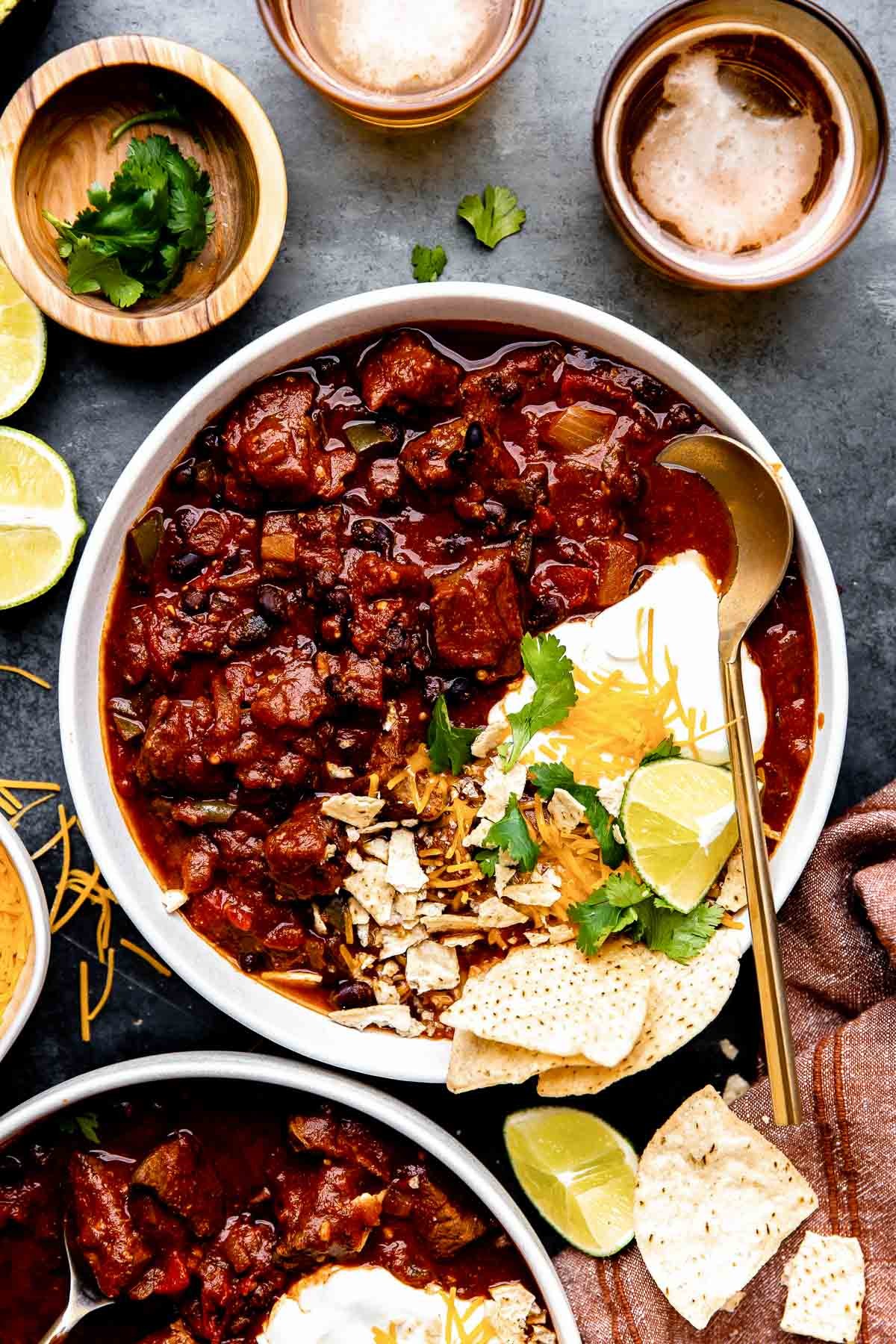 hearty chili-rubbed beef stew in a rustic bowl, steam rising, cozy setting