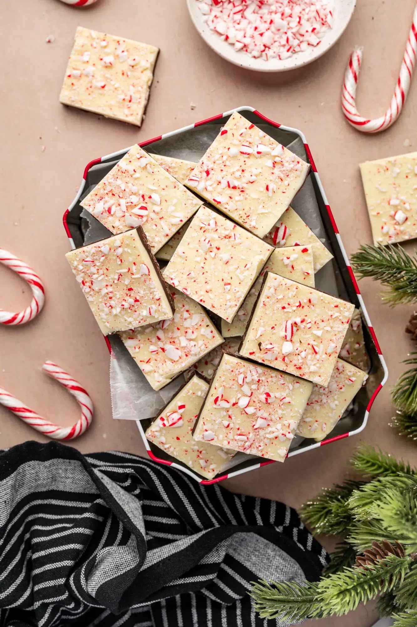 homemade peppermint bark with crushed candy canes on festive table setting