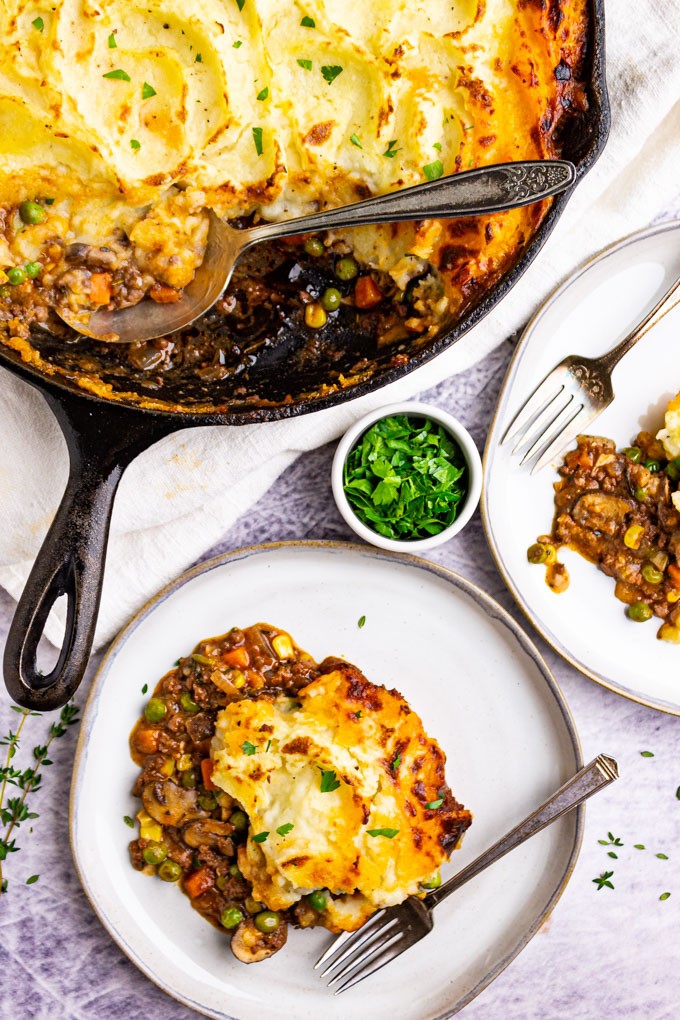 A rustic, hearty-looking freezer-friendly shepherd's pie in a casserole dish, garnished with fresh parsley.