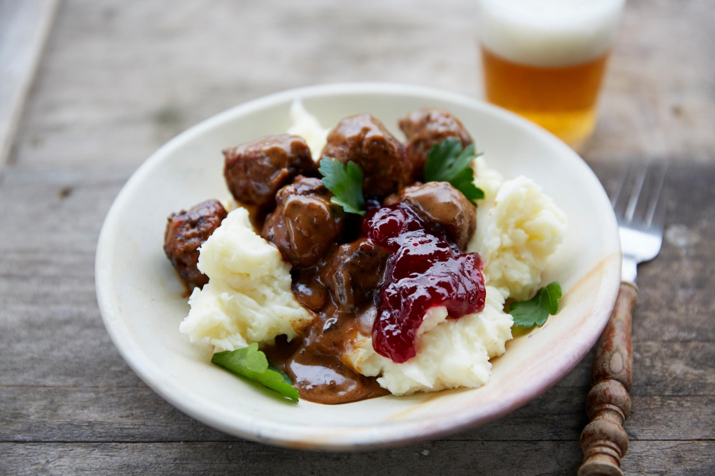 Close-up shot of spicy köttbullar with chipotle mayo, served with mashed potatoes and lingonberry jam