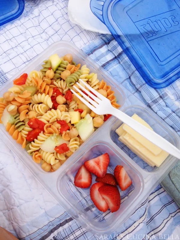 colorful pasta salad in a portable container, ready for a road trip picnic