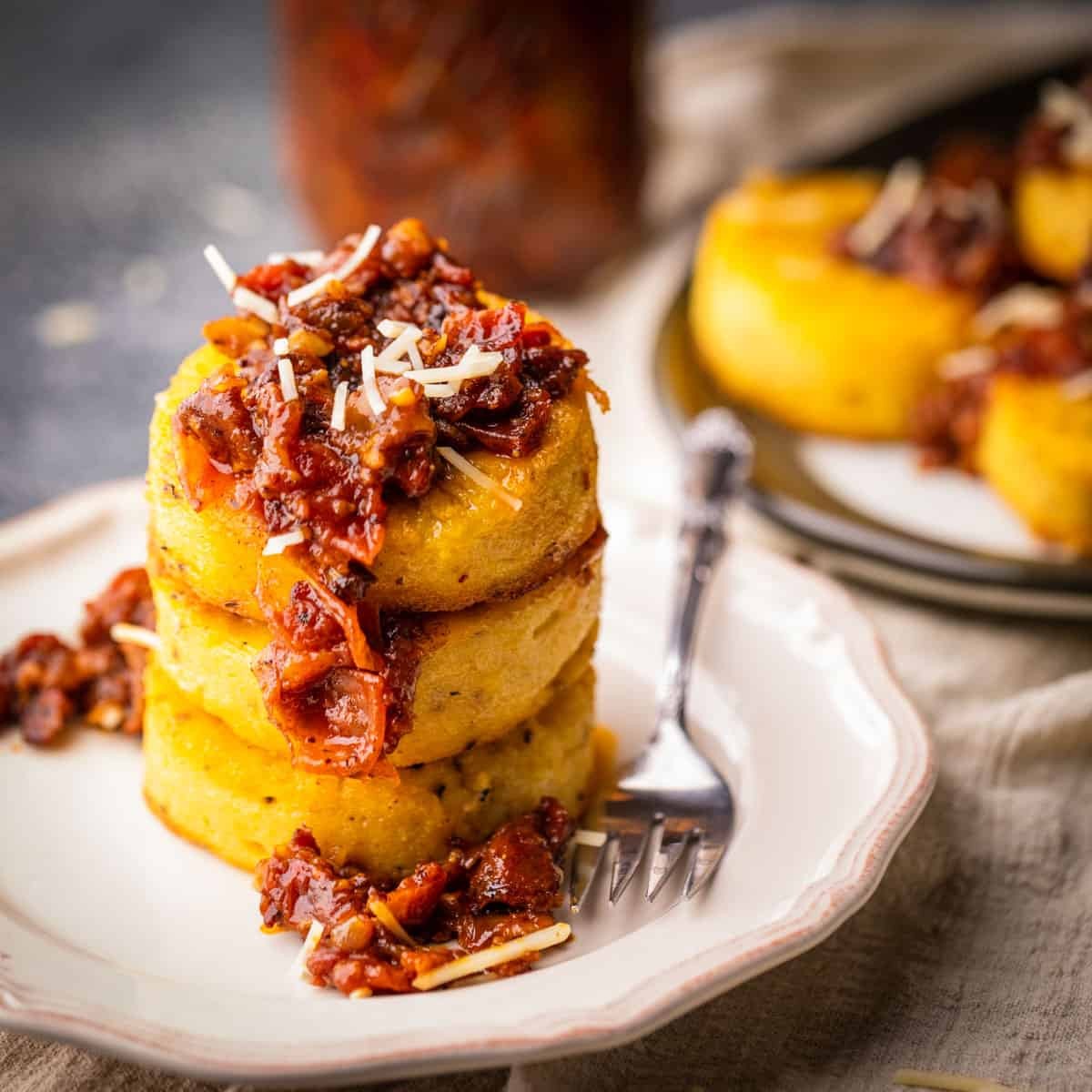 toasted coconut polenta cakes on a rustic wooden table