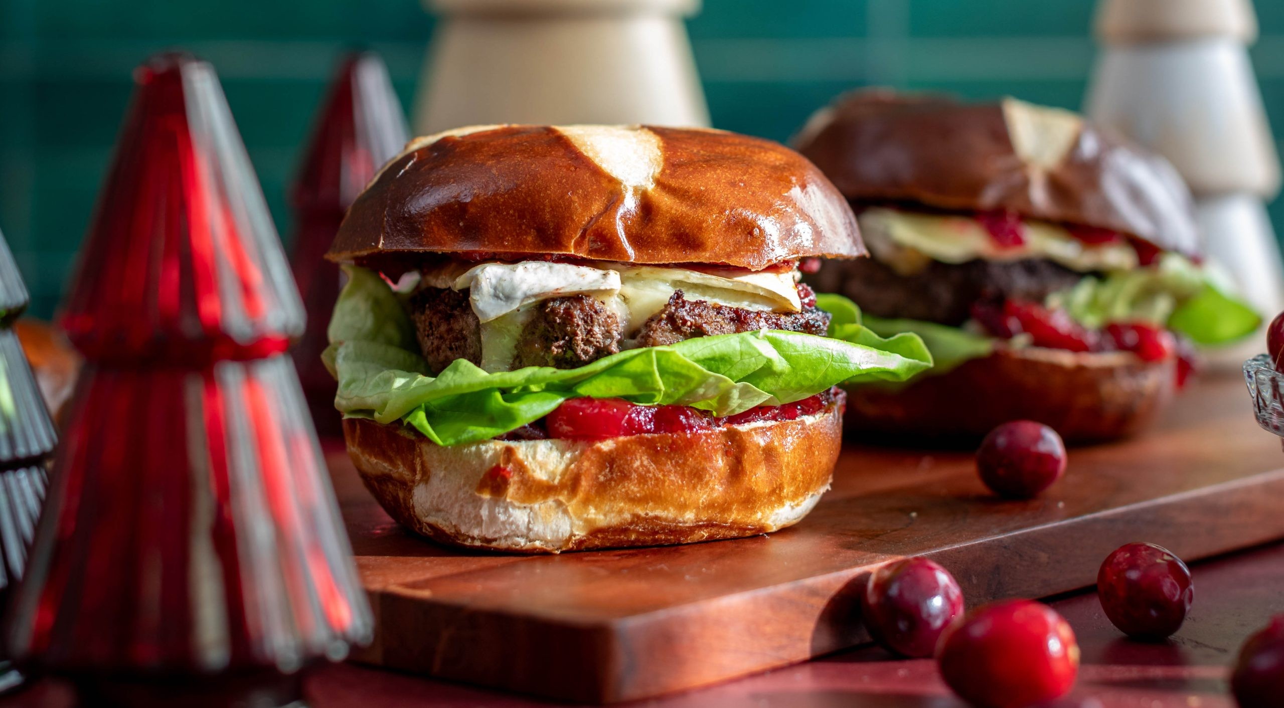 a gourmet cranberry brie ramen burger on a wooden board