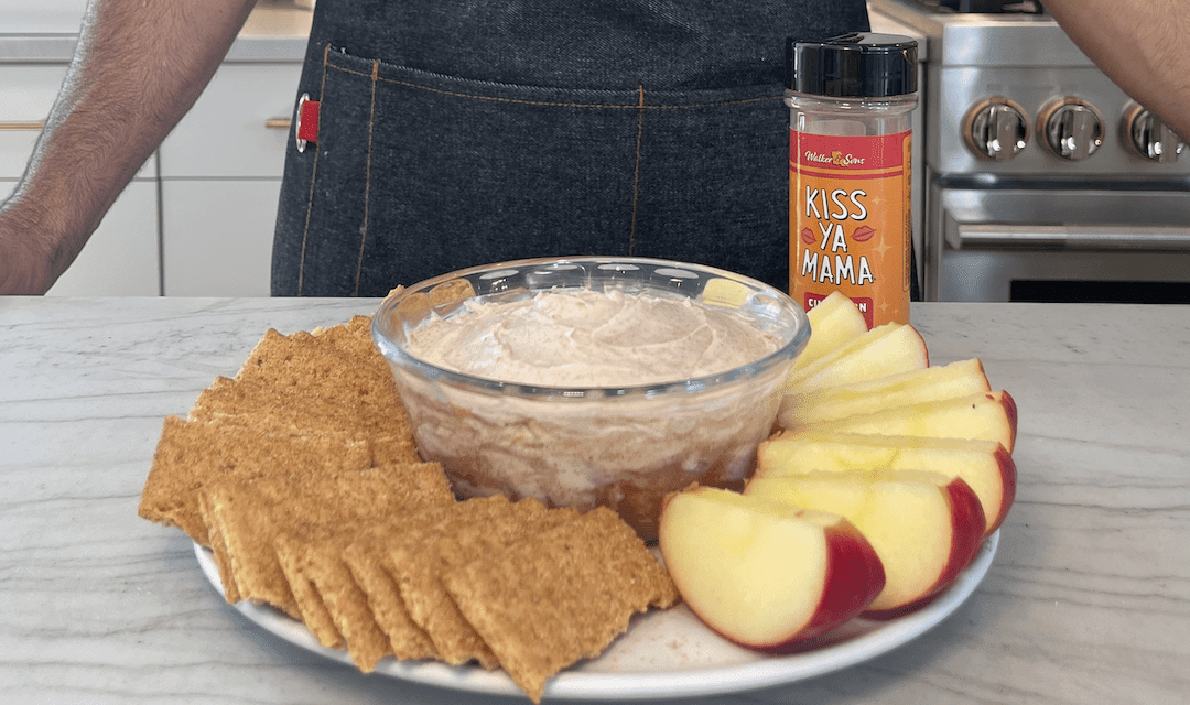 cinnamon roll dip with cream cheese frosting served with graham crackers and apple slices