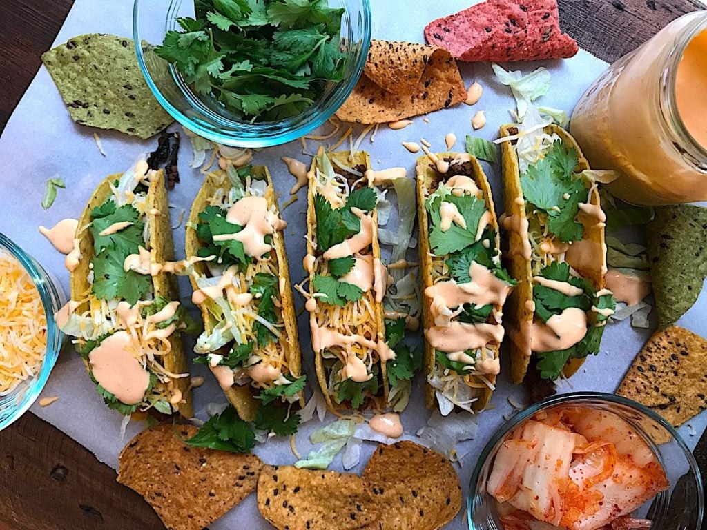 Kimchi and Crab Tacos with Spicy Mayo on a rustic wooden table
