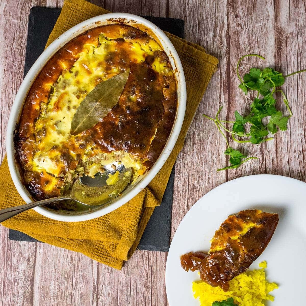 Bobotie with a golden crust, garnished with bay leaves