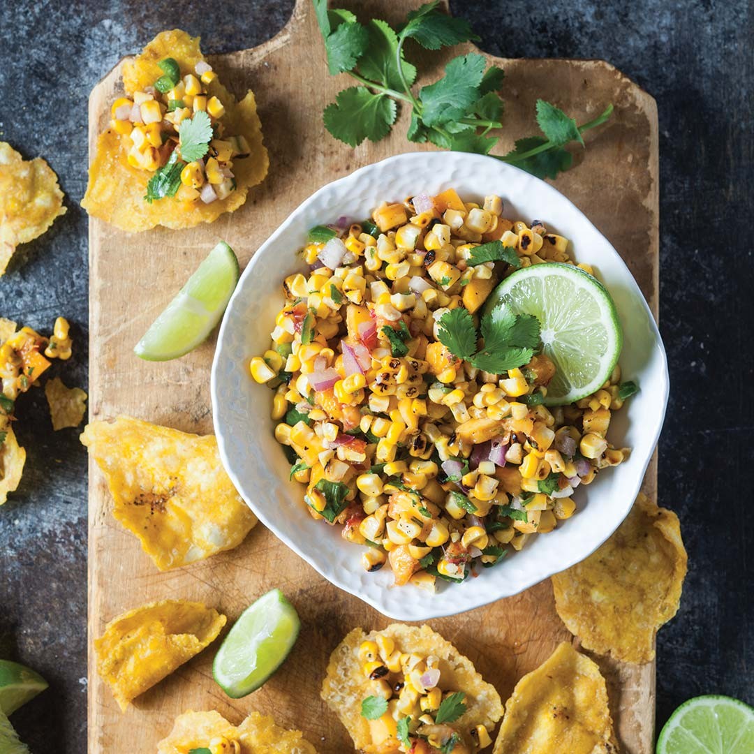 Grilled corn and peach salsa with cinnamon sugar in a rustic bowl